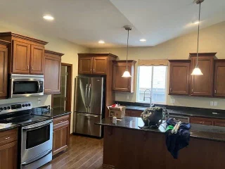 A kitchen with wood cabinets and recessed lights, captioned Spanaway, Washington on LLN’s homepage